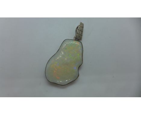 An opal white metal mounted pendant tests as silver, 4.5cm x 3cm 