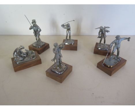 Six silver models each a character of different form including the golfer, the poacher, the fisherman etc, all on wooden base