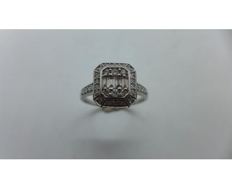 A 9ct white gold diamond octagonal cluster ring with four baguette cut diamonds and six brilliant cut diamonds, surrounded by