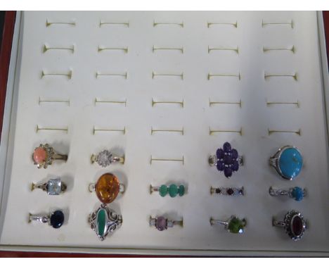 A collection of twelve silver rings, set with various semi precious stones including turquoise, amethyst, amber etc, and thre