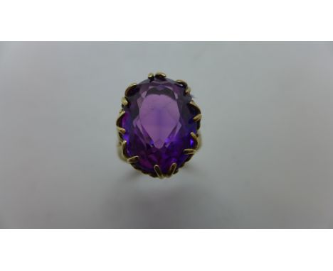 A large gold and amethyst dress ring, stone measures approx 18x13mm, ring size P, not hallmarked but tested as 9ct, clean con