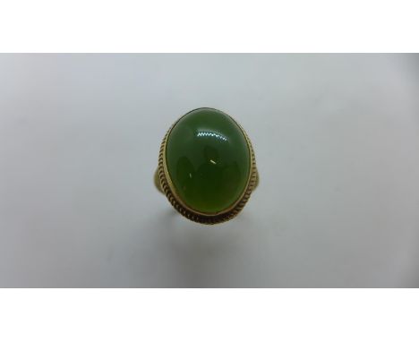 A 9ct hallmarked yellow gold jade ring, size L, head 18x12mm approx, approx 3.5 grams, generally good 