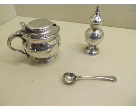 An English silver mustard, missing its liner and a pepperette, some surface marks and minor dents, with a silver plated spoon