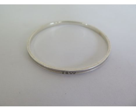 A silver Tiffany and Co bangle, 6.5cm diameter, some marks consistent with use otherwise good 