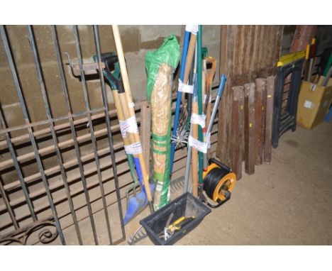 A quantity of various garden tools and an extension lead
