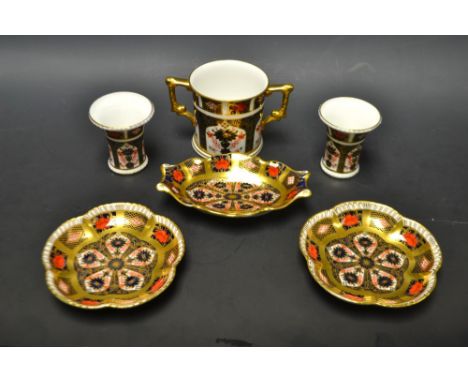 A Royal Crown Derby Imari 1128 pattern two-handled loving cup; a pair of miniature flared vases; a pair of five petal dishes;