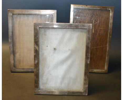 An Art Deco silver photograph frame, engine turned triple band decoration, Birmingham 1929, others, marks worn (3)