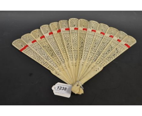 A Cantonese bone brisé thirteen fold fan, the sticks pierced with decorative motifs, strung with red silk, 25.8cm long, c. 18