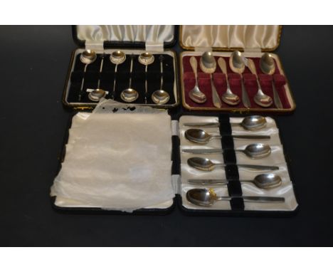 A set of six siver teaspoons, chevron terminals, Sheffield 1954, cased; a set of six silver coffee spoons, coffee bean termin
