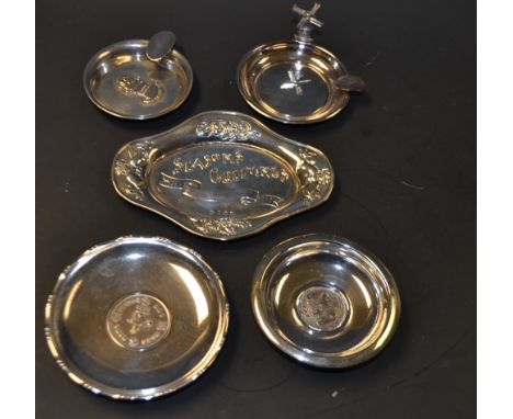 A silver trinket dish, the centre set with a Hong Kong dollar, marked sterling; other continental silver souvenier trinket di