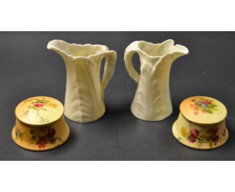 A pair of Royal Worcester lidded dressing table pots, painted with flowers, blush ivory ground, a pair of leaf jugs (4)