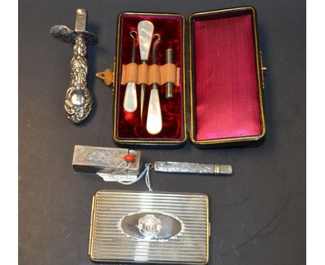 A late Victorian silver sealing wax holder, embossed with floral scrolls, Birmingham 1901; an Edwardian silver pencil and cov