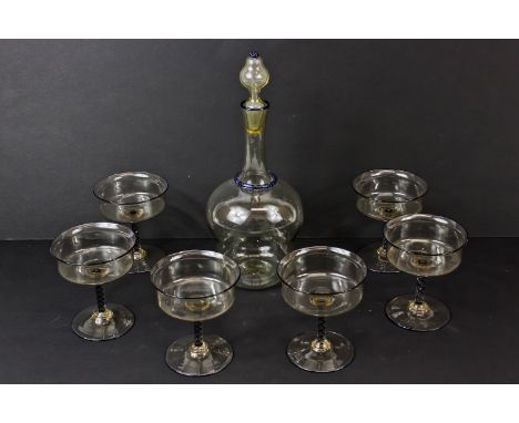 A Salviati glass service, comprising decanter, stopper and six champagne coupes, of smoked glass with blue enamel twist and d