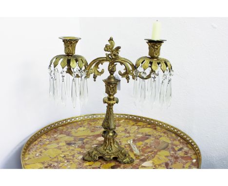 An ormolu two-light table lustre, with clear glass drops, 36cm high approx.