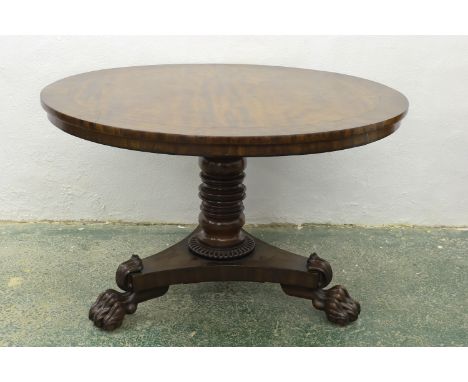 A mahogany and burr walnut tilt-top circular centre table, on tripod base with stiff leaf terminals and lion paw feet, 123cm 