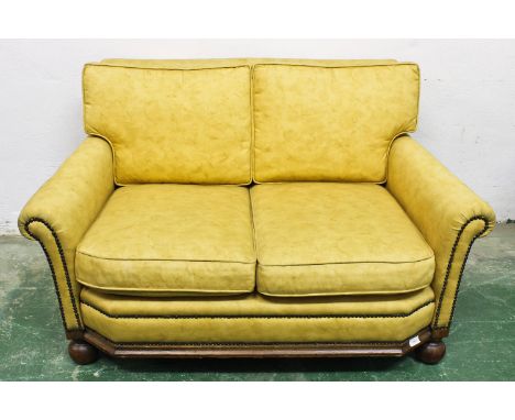 An Art Deco yellow upholstered sofa, 121cm x 70cm x 72cm approx.