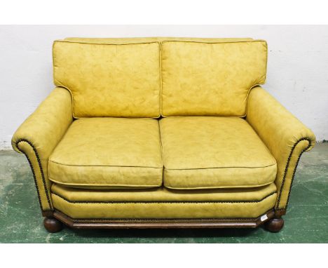 An Art Deco yellow upholstered sofa, 121cm x 70cm x 72cm approx.