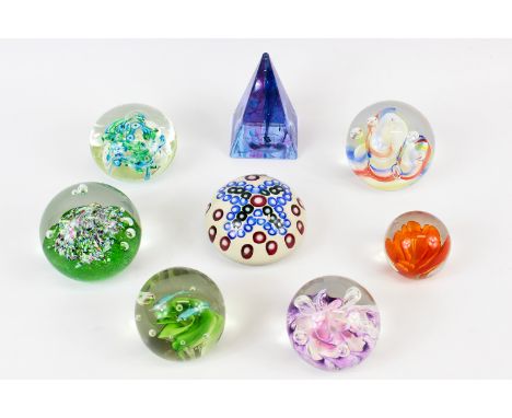 Eight paperweights including a Val St Lambert example of quatrefoil pattern canes on an opaque cream ground, paper label, and