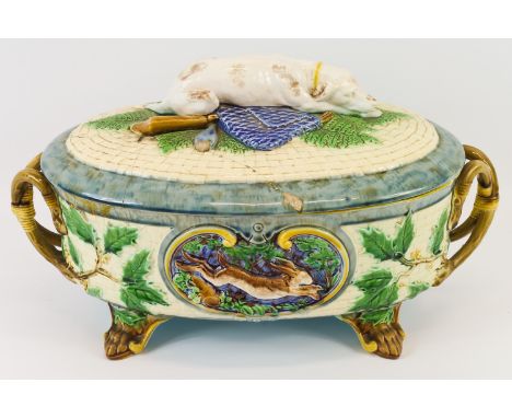 A Minton 'Hunting Dog' majolica tureen of basket form, the sides moulded with cartouche of game beneath a cover surmounted by