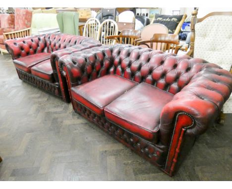 A pair of two seater button backed Chesterfields settee's in antique red leather