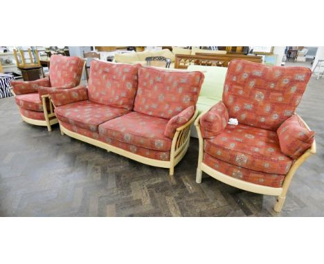 An Ercol light wood framed three piece lounge suite with loose terracotta patterned cushion with wooden leg extension pieces 
