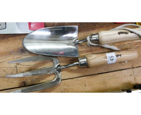A stainless steel hand trowel and hand fork