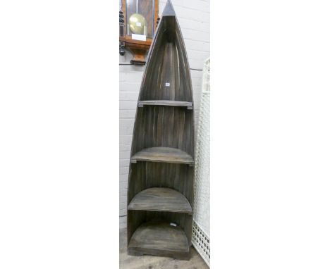A tall boat shaped reclaimed timber bookcase or display shelf with painted decoration 