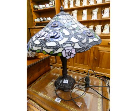 A Tiffany style electric table lamp with floral pattern shade 