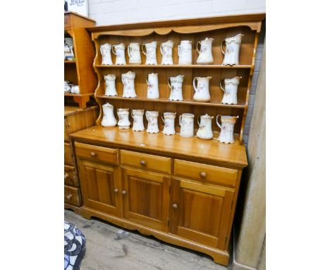 A modern pine kitchen dresser with shelf back, three drawers and doors under, 4'6 wide 