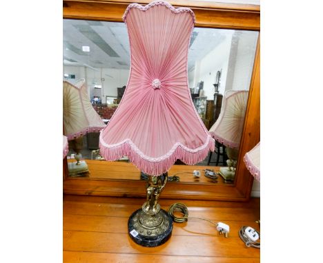 A brass cherub and onyx table lamp with pink fringed shade 