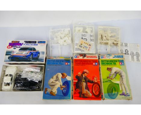 Tamiya - Fujimi - Four boxed model kits. Lot consists of Tamiya #1203 1:12 scale Motor Racing Team Mechanic 'Engine Tuning'; 