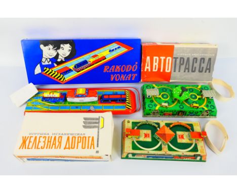 Vintage Tinplate - 3 x boxed Eastern European clockwork tinplate models, one roadway set and two rail sets. They appear Near 