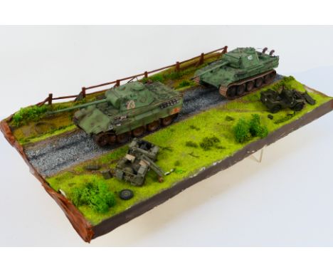 Tamiya - A WWII diorama created using Tamiya 1:35 scale model kits, this battle scene constructed on a wooden base features 2