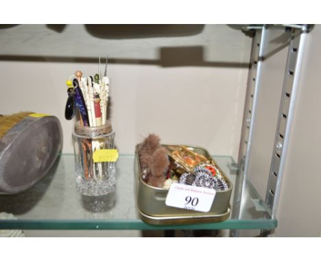 A tin containing a yellow metal brooch; a small mico mozaic trinket box; various other costume jewellery; a quantity of knitt