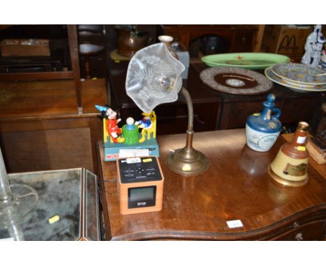 A DAB radio alarm clock; a Mickey Mouse night light; and a brass desk lamp