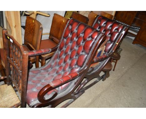 A pair of mahogany and red leather button down rocking chairs