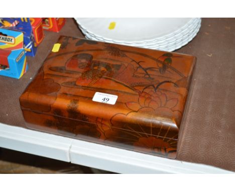 An oriental wooden and decorated trinket box and lid 