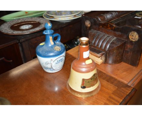 A Wade Bells Scotch Whisky decanter and contents; and a Lambs Navy Rum decanter (lacking contents) 