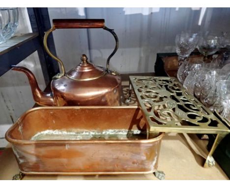 Copper kettle, a copper trough form planter with lion mask handles, and a brass trivet. Not available for in-house P&amp;P