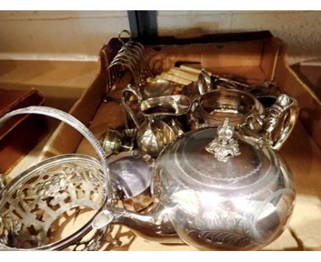 Collection of silver plated items to include a three piece tea service, toast rack loose cutlery, a WMF pierce work basket. N