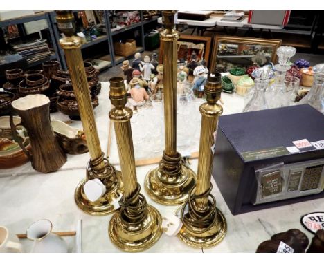 Two pairs of brass lamps. All electrical items in this lot have been PAT tested for safety and have passed. This does not con