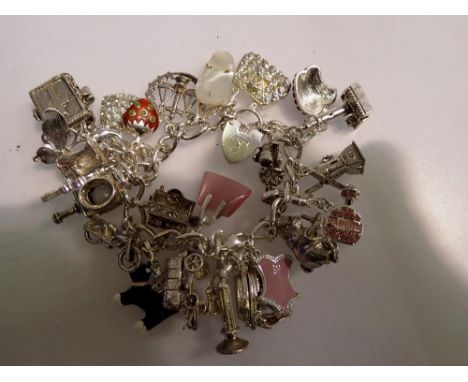 White metal charm bracelet with hallmarked silver padlock clasp. UK P&amp;P Group 1 (£16+VAT for the first lot and £2+VAT for