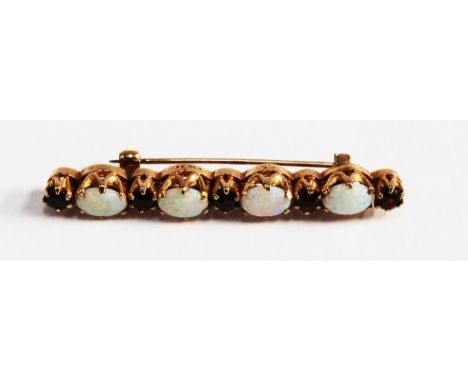 A 9ct gold opal and ruby bar brooch.

TO BE SOLD ON BEHALF OF CATS PROTECTION, DERBYSHIRE