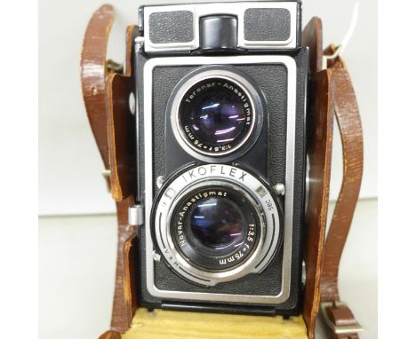 A Zeiss Ikon Ikoflex camera, in leather case and with plastic lens protector