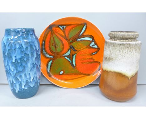 Three pieces of mid-Century pottery to include a Poole Pottery Delphis charger, a blue drip glaze West German vase 242-22 (a/