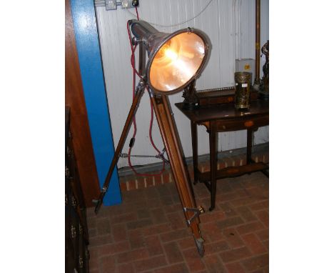 A retro industrial style floor lamp with adjustable tripod stand