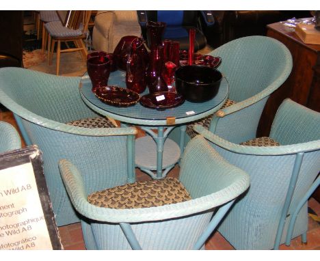 A Lloyd Loom lawn suite comprising a glass topped circular table and four tub chairs (diameter of table approx. 78cm) 
