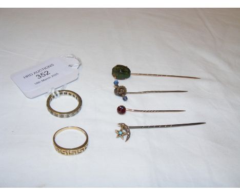 A gold ring, stick pin etc.