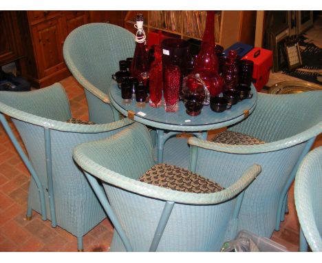 A Lloyd Loom lawn suite comprising a glass topped circular table and four tub chairs (diameter of table approx. 78cm) 