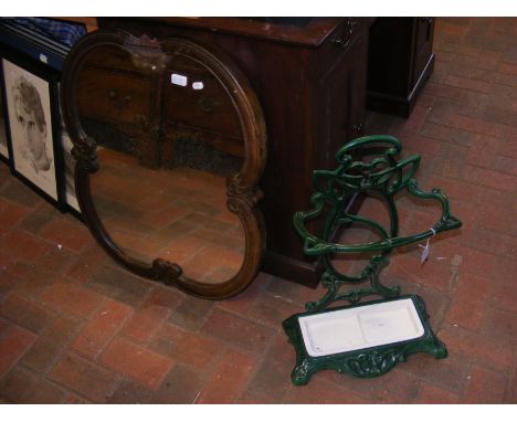 An old green stick and umbrella stand, together with a wall mirror 